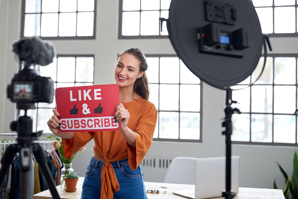 Youtube Vlogger telling viewers to like her video and channel