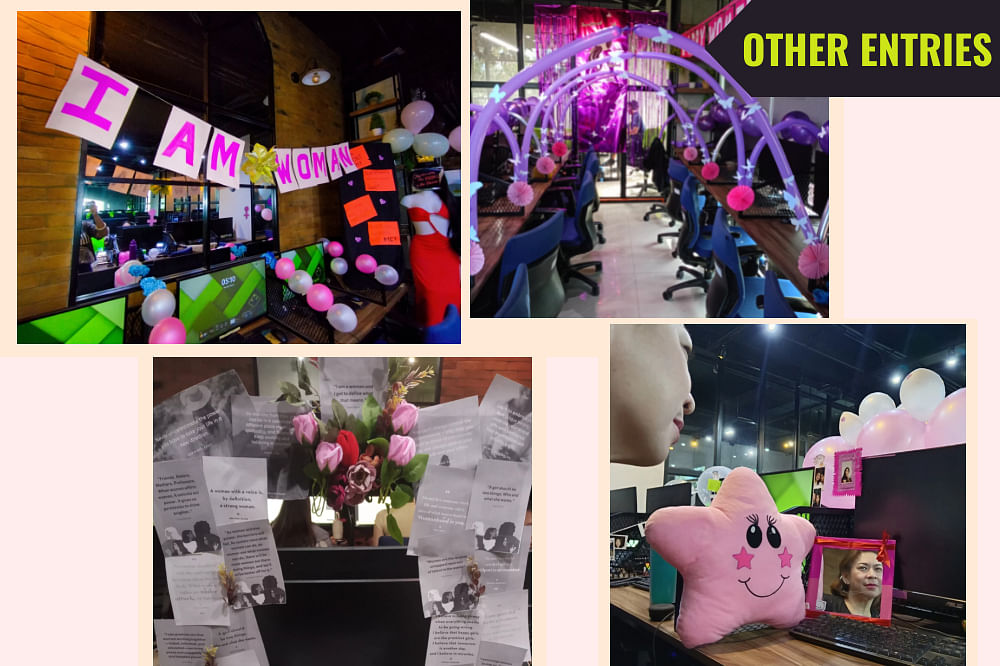 Decorated office space with balloons, flowers, pink stuffed star, and signs reading